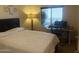 Comfortable bedroom with a large bed, window with blinds, and a desk setup at 5350 E Deer Valley Dr # 3267, Phoenix, AZ 85054