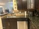 Kitchen showcasing a stainless steel dishwasher, dark cabinetry, and a sink with granite countertops at 5350 E Deer Valley Dr # 3267, Phoenix, AZ 85054