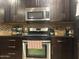 Well-equipped kitchen featuring stainless steel appliances, granite countertops, and rich, dark wood cabinetry at 5350 E Deer Valley Dr # 3267, Phoenix, AZ 85054