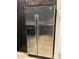 Side-by-side stainless steel refrigerator with water and ice dispenser complements the dark wood cabinetry at 5350 E Deer Valley Dr # 3267, Phoenix, AZ 85054