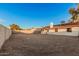 Expansive dirt backyard with a covered patio, perfect for customization and outdoor entertaining at 6244 E Inglewood St, Mesa, AZ 85205