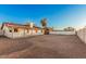 Spacious gravel backyard with covered patio extending from home, ideal for outdoor enjoyment at 6244 E Inglewood St, Mesa, AZ 85205
