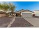 Charming single-story home featuring a desert landscape, two-car garage, and stone accents at 6244 E Inglewood St, Mesa, AZ 85205