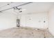 Bright garage with an overhead garage door and water heater at 6244 E Inglewood St, Mesa, AZ 85205