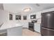 Modern kitchen featuring stainless steel appliances, quartz countertops, and bright natural light at 6244 E Inglewood St, Mesa, AZ 85205