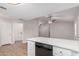 Open kitchen with quartz countertops, modern appliances, and seamless transition to living area at 6244 E Inglewood St, Mesa, AZ 85205