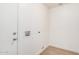 Functional laundry room featuring white walls and door at 6244 E Inglewood St, Mesa, AZ 85205
