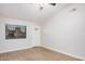 Spacious living room featuring a window, door, and modern light-colored flooring at 6244 E Inglewood St, Mesa, AZ 85205