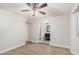 Spacious main bedroom with a ceiling fan and en-suite bathroom featuring modern fixtures at 6244 E Inglewood St, Mesa, AZ 85205