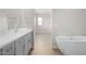 Bright bathroom featuring a double vanity and modern soaking tub, offering a spa-like experience at 651 W Laredo St, Chandler, AZ 85225