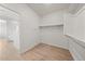 Spacious walk-in closet providing ample storage with clean, simple shelving and light-colored flooring at 651 W Laredo St, Chandler, AZ 85225