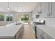 Modern kitchen with gray cabinets, white countertops, stainless appliances, and access to the backyard at 651 W Laredo St, Chandler, AZ 85225