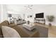 Bright, open-concept living room with modern furnishings and hardwood floors flowing into an adjacent kitchen at 651 W Laredo St, Chandler, AZ 85225