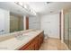 Bathroom with double sinks, walk-in shower, tiled floor, and plenty of storage at 7157 E Rancho Vista Dr # 5004, Scottsdale, AZ 85251