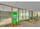 Building entrance with modern glass doors, a secure entry system, and green signage at 7157 E Rancho Vista Dr # 5004, Scottsdale, AZ 85251