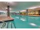 Inviting indoor swimming pool with clear blue water, surrounded by lounge seating and lush greenery at 7157 E Rancho Vista Dr # 5004, Scottsdale, AZ 85251