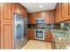 Well-appointed kitchen boasting stainless steel appliances, granite counters, and warm cabinetry at 7157 E Rancho Vista Dr # 5004, Scottsdale, AZ 85251