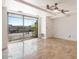 Bright living room with travertine flooring, balcony, and a modern ceiling fan at 7157 E Rancho Vista Dr # 5004, Scottsdale, AZ 85251