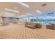 Spacious lounge area featuring comfortable seating, tables, and adjacent pool view, perfect for relaxation and socializing at 7157 E Rancho Vista Dr # 5004, Scottsdale, AZ 85251