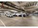 Underground parking garage with many parked cars and overhead lighting at 7157 E Rancho Vista Dr # 5004, Scottsdale, AZ 85251