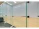 Modern racquetball court with glass walls, hardwood floors, and professional markings for competitive play at 7157 E Rancho Vista Dr # 5004, Scottsdale, AZ 85251