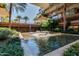 Serene water feature with lush plants, palm trees and stone accents in a courtyard setting at 7157 E Rancho Vista Dr # 5004, Scottsdale, AZ 85251
