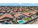 Beautiful aerial view of homes with red-tiled roofs in a well-kept neighborhood featuring backyards with private pools at 7464 E Lompoc Ave, Mesa, AZ 85209