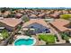 Inviting backyard with pool, landscaping and mature trees is showcased from above, offering a peaceful retreat at 7464 E Lompoc Ave, Mesa, AZ 85209