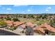 Beautiful aerial view of homes with red-tiled roofs in a well-kept neighborhood, near a greenbelt with mountain views at 7464 E Lompoc Ave, Mesa, AZ 85209