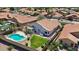 Tranquil backyard featuring a pool, lush lawn, and a covered patio, perfect for outdoor living and relaxation at 7464 E Lompoc Ave, Mesa, AZ 85209