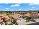 Aerial view of a home showcasing its well-manicured lawn, desert landscaping and convenient three-car garage at 7464 E Lompoc Ave, Mesa, AZ 85209