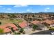 Beautiful aerial view of homes with red-tiled roofs in a well-kept neighborhood, near a greenbelt with mountain views at 7464 E Lompoc Ave, Mesa, AZ 85209