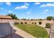 Lush backyard featuring healthy lawn and tidy, manicured landscaping at 7464 E Lompoc Ave, Mesa, AZ 85209