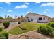 Expansive backyard featuring a lush lawn, mature landscaping, and decorative rock at 7464 E Lompoc Ave, Mesa, AZ 85209