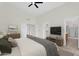 Spacious bedroom features neutral décor, a ceiling fan, and ensuite bathroom for enhanced privacy at 7464 E Lompoc Ave, Mesa, AZ 85209