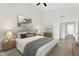 Bright bedroom features a neutral palette, ceiling fan, and an ensuite bathroom for added convenience at 7464 E Lompoc Ave, Mesa, AZ 85209