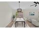 Elegant dining area with a modern light fixture and a view of the living area at 7464 E Lompoc Ave, Mesa, AZ 85209