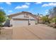 Charming home featuring a spacious two-car garage and beautifully maintained desert landscaping at 7464 E Lompoc Ave, Mesa, AZ 85209
