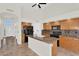 Spacious kitchen with an island, dark appliances, and wooden cabinets at 7464 E Lompoc Ave, Mesa, AZ 85209