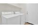 Neat laundry room featuring a white washer, dryer and handy shelving at 7464 E Lompoc Ave, Mesa, AZ 85209