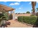 Covered patio area provides a shaded retreat with views of the beautifully landscaped backyard and sparkling pool at 7464 E Lompoc Ave, Mesa, AZ 85209