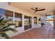 Covered patio with tiled flooring showcases access to the backyard, promising seamless indoor-outdoor living at 7464 E Lompoc Ave, Mesa, AZ 85209