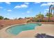 Inviting backyard pool surrounded by lush landscaping and a decorative block wall at 7464 E Lompoc Ave, Mesa, AZ 85209