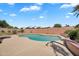 Backyard pool featuring a custom-shaped pool, surrounding patio and privacy wall at 7464 E Lompoc Ave, Mesa, AZ 85209