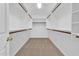 Well-organized walk-in closet with shelving and rods to keep clothes and accessories neatly stored at 7464 E Lompoc Ave, Mesa, AZ 85209