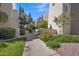 Charming walkway lined with mature trees and colorful flower beds for a scenic view at 7625 E Camelback Rd # B244, Scottsdale, AZ 85251