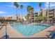 Resort-style pool with sun loungers and lush palm trees offers a relaxing community space at 7625 E Camelback Rd # B244, Scottsdale, AZ 85251