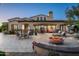 Stunning backyard showcasing a sprawling covered patio, elegant outdoor seating, and a cozy fire pit at 7753 E Whisper Rock Trl, Scottsdale, AZ 85266