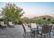 Backyard patio with comfortable seating, desert landscaping, and a fire pit, perfect for outdoor entertaining at 7753 E Whisper Rock Trl, Scottsdale, AZ 85266