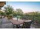 Cozy backyard setting featuring an outdoor dining table, desert landscaping, and mountain views at 7753 E Whisper Rock Trl, Scottsdale, AZ 85266